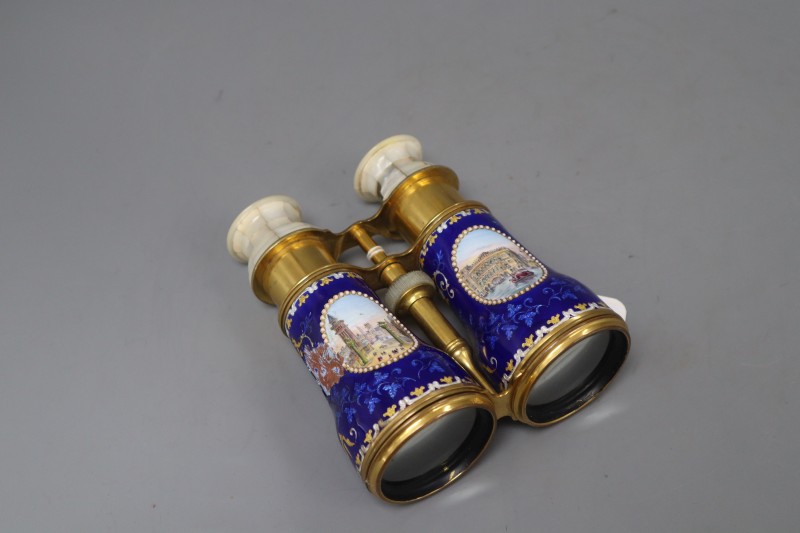 A pair of gilt brass and enamel opera glasses, with mother of pearl overlay and painted Italian scenes, length 13.5cm (a.f.)